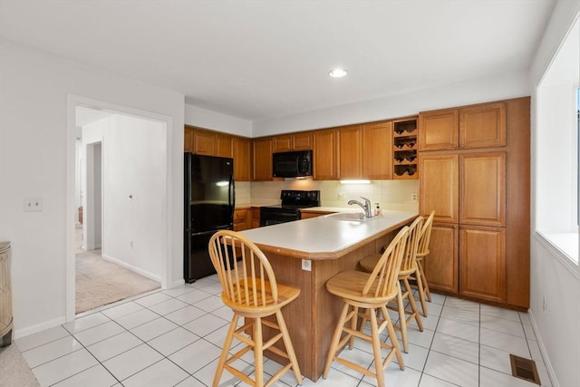 79 Brookdale Cir Unit 79, Shrewsbury, MA 01545 - kitchen with black appliances, a sink, a peninsula, light countertops, and open shelves