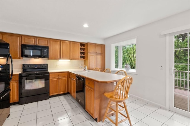 79 Brookdale Cir Unit 79, Shrewsbury, MA 01545 - kitchen featuring black appliances, a peninsula, light countertops, a sink, and open shelves