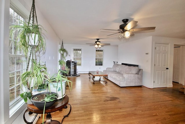 living area with baseboards and light wood-style floors