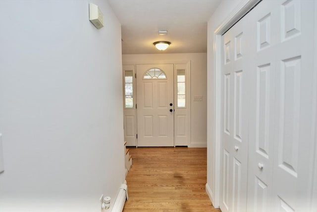 entrance foyer featuring light wood-style flooring and baseboards