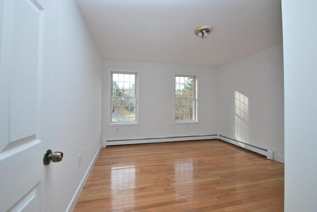 unfurnished room with baseboards and light wood finished floors