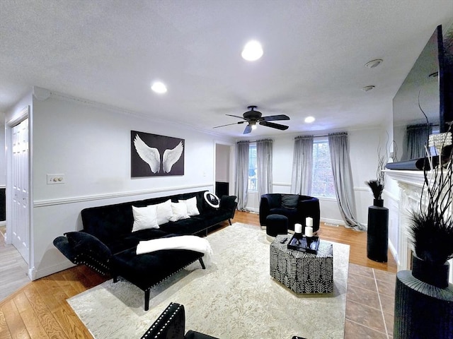 living room with ceiling fan and light wood-type flooring