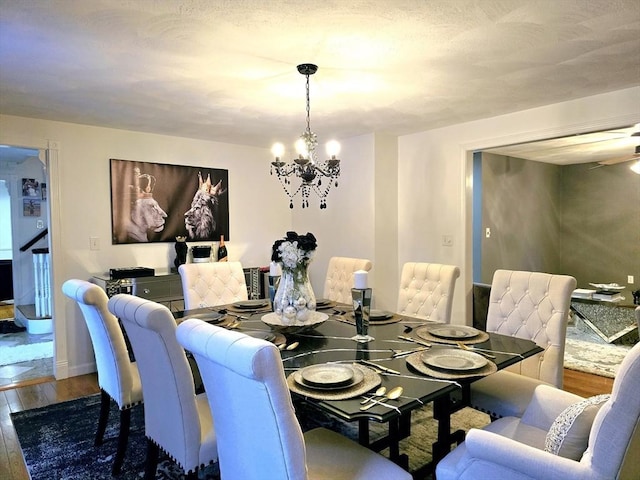 dining area with dark hardwood / wood-style floors and a chandelier