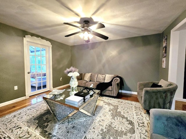 living room featuring hardwood / wood-style flooring and ceiling fan