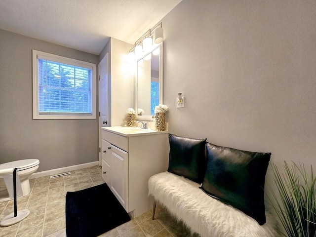 bathroom featuring vanity, tile patterned floors, and toilet