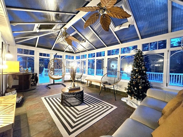 sunroom with lofted ceiling and ceiling fan