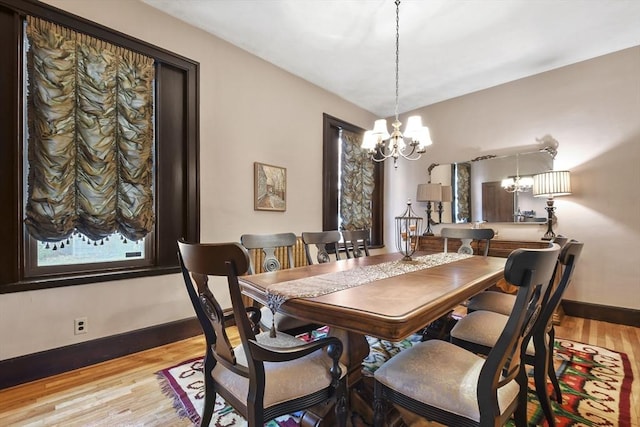 97 Livingston Ave, Lowell, MA 01851 - dining space featuring light wood-style flooring, baseboards, and an inviting chandelier