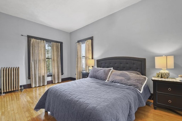 97 Livingston Ave, Lowell, MA 01851 - bedroom with radiator heating unit, light wood finished floors, and baseboards