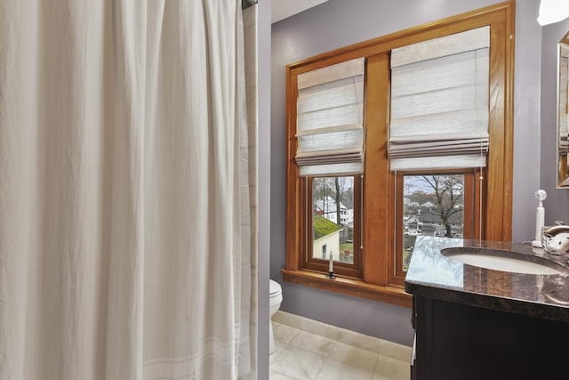 97 Livingston Ave, Lowell, MA 01851 - bathroom featuring vanity, toilet, curtained shower, marble finish floor, and baseboards