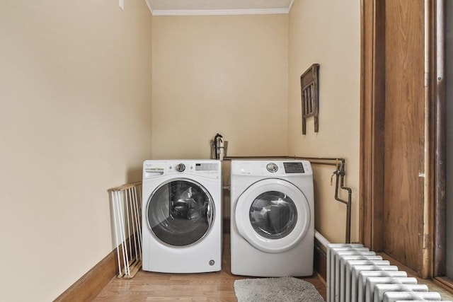 97 Livingston Ave, Lowell, MA 01851 - laundry room featuring crown molding, radiator heating unit, washing machine and dryer, and wood finished floors