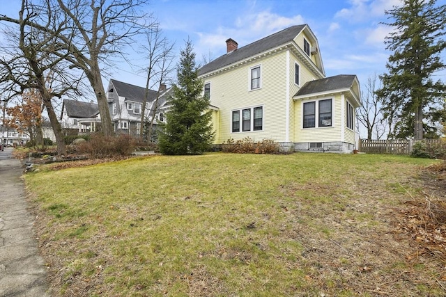 97 Livingston Ave, Lowell, MA 01851 - view of property exterior with fence, a yard, a chimney, and a shingled roof
