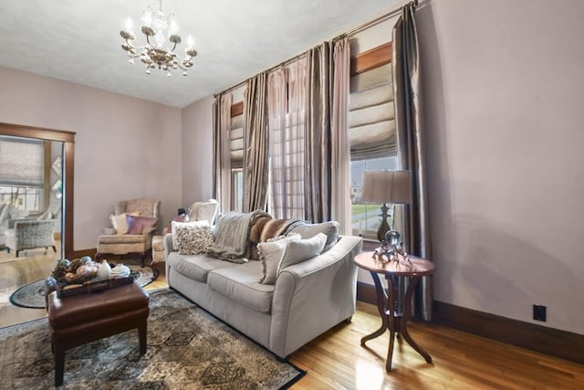 97 Livingston Ave, Lowell, MA 01851 - living room featuring baseboards, plenty of natural light, an inviting chandelier, and wood finished floors