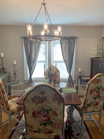 dining room with a notable chandelier and wood-type flooring