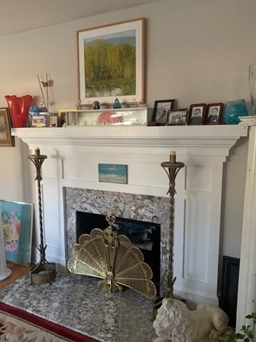 interior details with a high end fireplace and hardwood / wood-style flooring