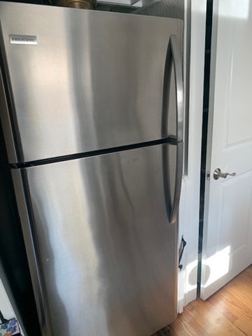 interior space with light hardwood / wood-style flooring and stainless steel refrigerator