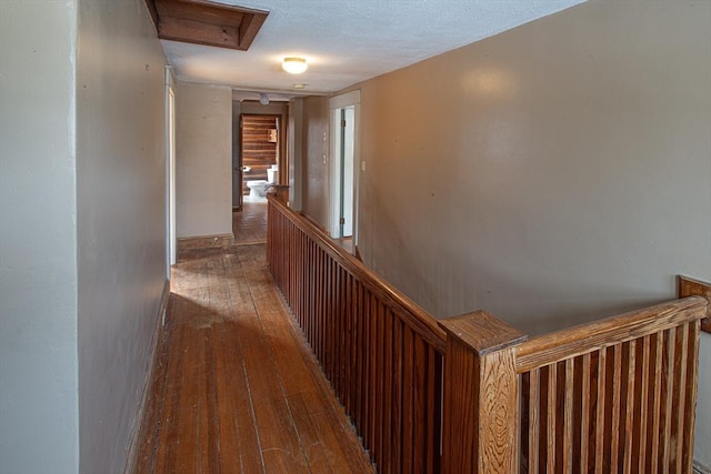 hallway with hardwood / wood-style floors