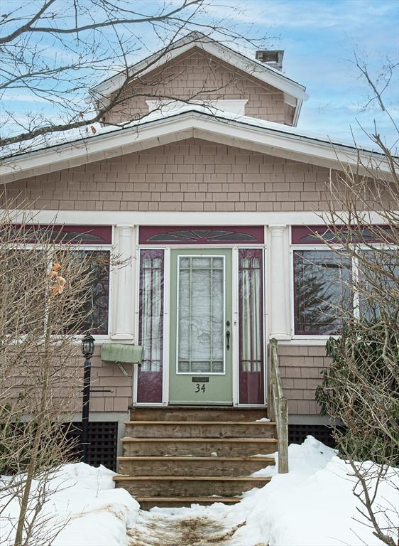 view of snow covered property entrance