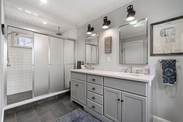 bathroom featuring double vanity, ornamental molding, a stall shower, and a sink