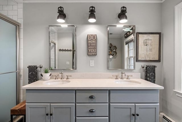 bathroom featuring a sink, a baseboard heating unit, and double vanity