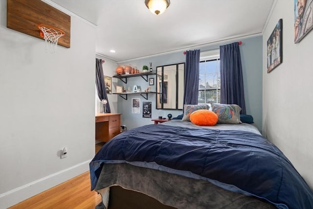 bedroom with recessed lighting, ornamental molding, baseboards, and wood finished floors