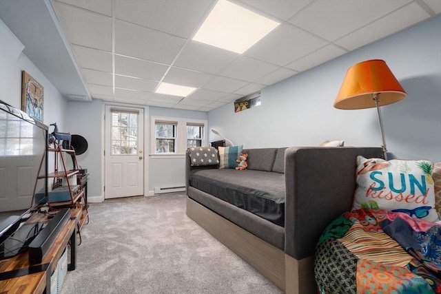 carpeted bedroom with a drop ceiling and baseboard heating