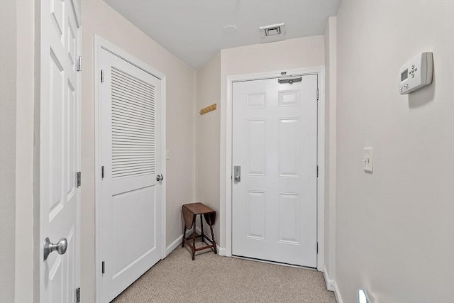 doorway to outside featuring light colored carpet