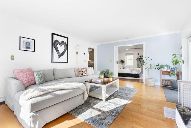 living area with crown molding and wood finished floors