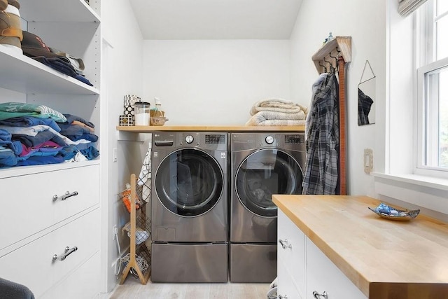 laundry room featuring laundry area, washing machine and dryer, and light wood finished floors