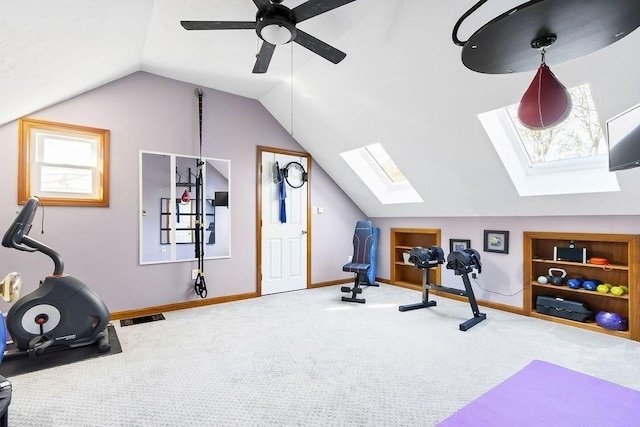 exercise room with carpet flooring, ceiling fan, baseboards, visible vents, and lofted ceiling with skylight