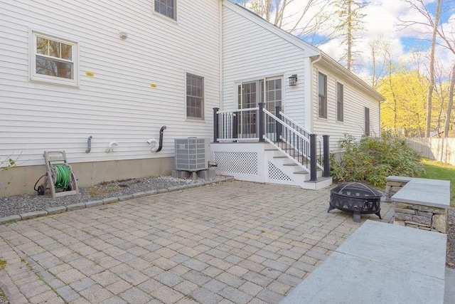 view of patio with central AC unit and an outdoor fire pit