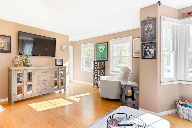 sitting room featuring baseboards and light wood-style floors