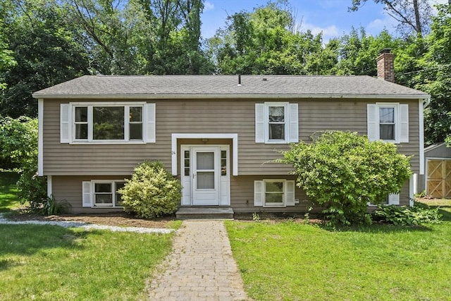 24 Lynn Ln, Southbridge, MA 01550 - split foyer home featuring a chimney and a front lawn