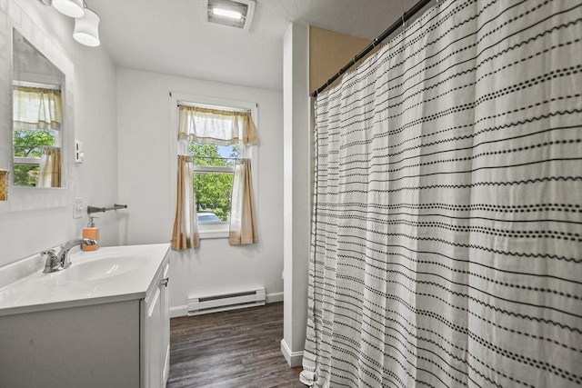 24 Lynn Ln, Southbridge, MA 01550 - bathroom featuring a baseboard heating unit, vanity, wood finished floors, and curtained shower