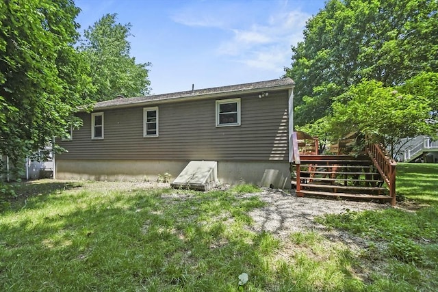 24 Lynn Ln, Southbridge, MA 01550 - back of property featuring a wooden deck and a lawn