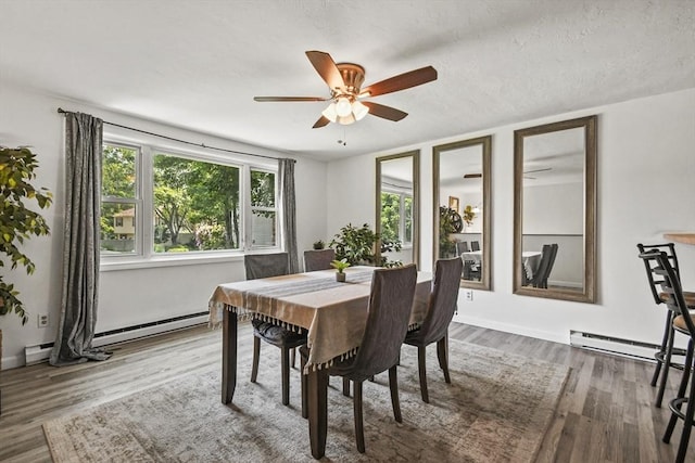 24 Lynn Ln, Southbridge, MA 01550 - dining area featuring ceiling fan, wood finished floors, and a baseboard heating unit