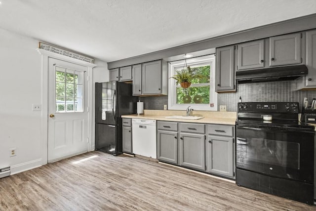 24 Lynn Ln, Southbridge, MA 01550 - kitchen with black appliances, under cabinet range hood, gray cabinets, backsplash, and a textured ceiling