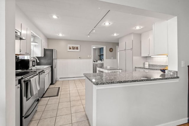 12 Summit Ave Unit 1, Salem, MA 01970 - kitchen with stainless steel appliances, baseboard heating, wainscoting, a peninsula, and white cabinets