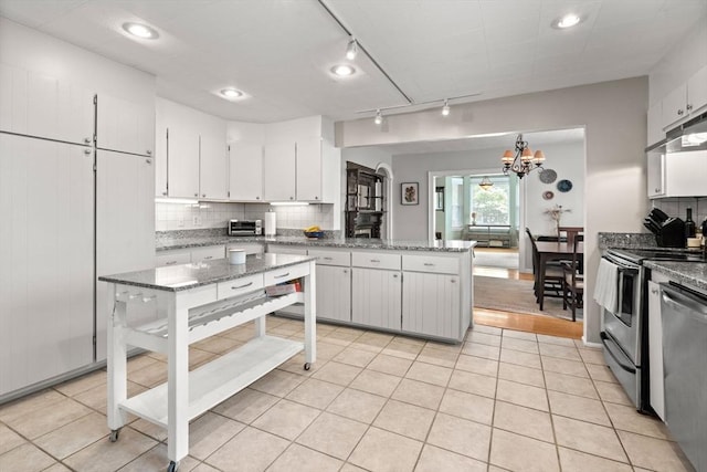 12 Summit Ave Unit 1, Salem, MA 01970 - kitchen with appliances with stainless steel finishes, track lighting, a peninsula, decorative backsplash, and white cabinetry