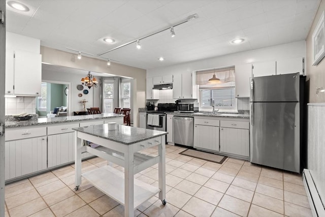 12 Summit Ave Unit 1, Salem, MA 01970 - kitchen with stainless steel appliances, a baseboard radiator, decorative backsplash, and plenty of natural light