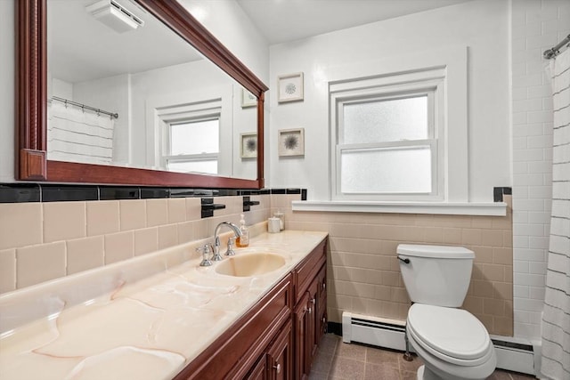 12 Summit Ave Unit 1, Salem, MA 01970 - full bath featuring baseboard heating, tile walls, vanity, tiled shower, and a wainscoted wall