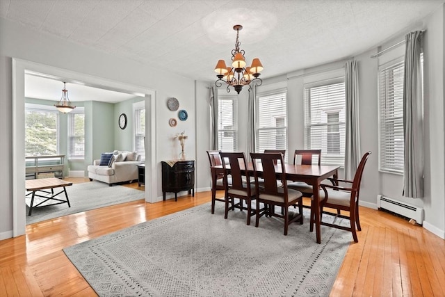12 Summit Ave Unit 1, Salem, MA 01970 - dining space with a baseboard radiator, hardwood / wood-style floors, and a chandelier