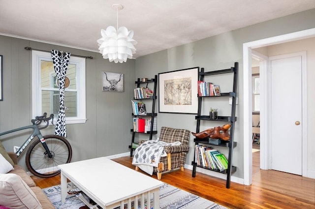 home office featuring an inviting chandelier and wood finished floors