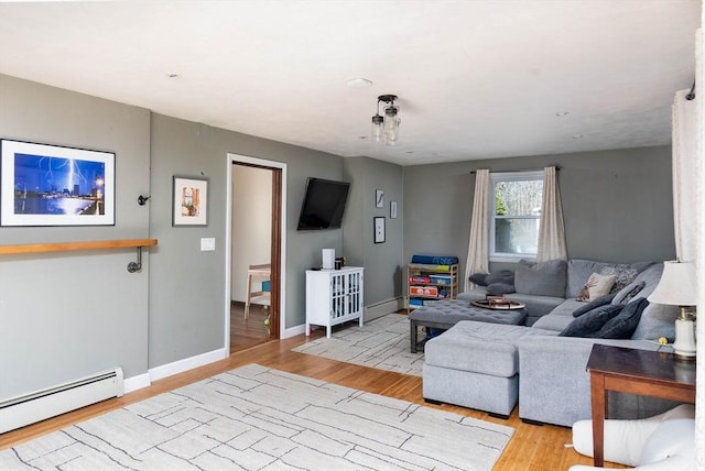 living room with baseboard heating, wood finished floors, baseboards, and a baseboard radiator