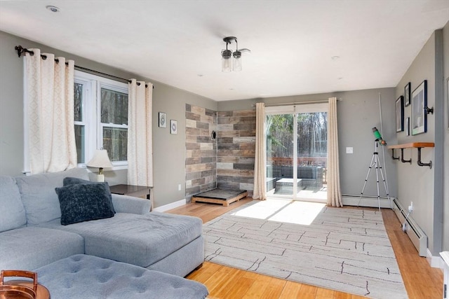 living room with wood finished floors, baseboards, and baseboard heating