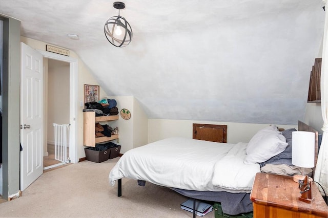 bedroom featuring lofted ceiling and carpet