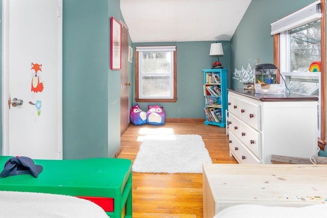 bedroom with baseboards and wood finished floors