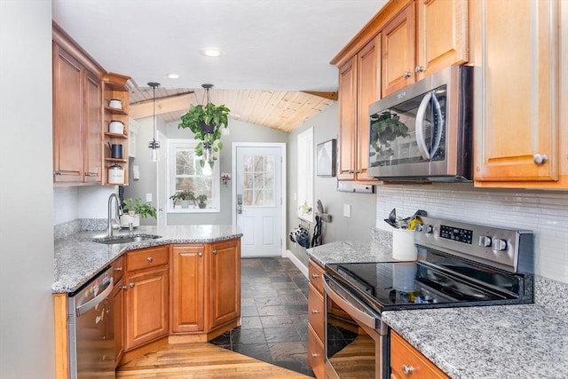 kitchen with a sink, vaulted ceiling, stone tile flooring, stainless steel appliances, and open shelves