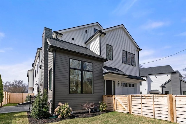 25 Johnson Pl Unit 25, Newton, MA 02466 - back of property featuring an attached garage and roof with shingles