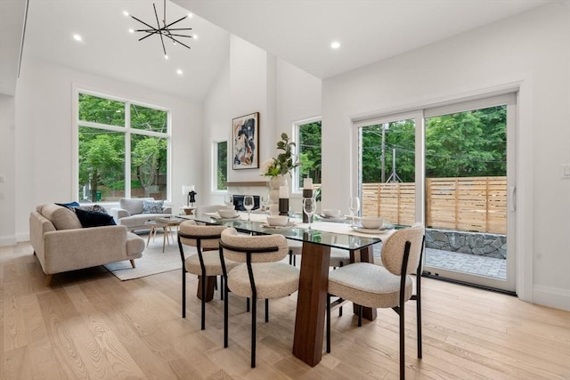 25 Johnson Pl Unit 25, Newton, MA 02466 - dining space featuring light wood-style floors, high vaulted ceiling, a chandelier, and recessed lighting