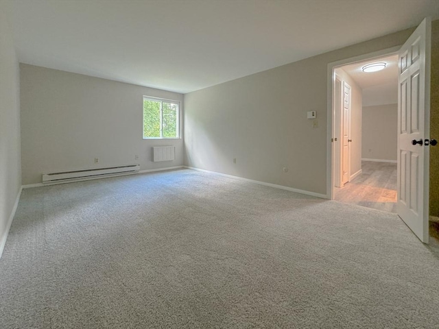 carpeted empty room with baseboards, visible vents, and a baseboard radiator